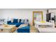 A stylish living room featuring a large blue sofa, dining space, and modern décor for comfortable living at 12405 3Rd E St # 306, Treasure Island, FL 33706