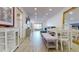 Well-lit open concept living space with dining area, kitchen access, and relaxing water view at 12405 3Rd E St # 306, Treasure Island, FL 33706