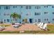Relax on the brick patio with outdoor seating and admire the building's bright blue facade at 12405 3Rd E St # 306, Treasure Island, FL 33706