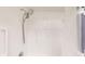 Shower with adjustable shower head and white tile with a striped shower curtain is shown at 12405 3Rd E St # 306, Treasure Island, FL 33706
