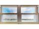 View of a sunny day through divided windows overlooking a waterway with homes and boats at 12405 3Rd E St # 306, Treasure Island, FL 33706