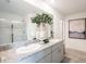 Elegant bathroom showcasing double vanity with granite countertop and glass-enclosed shower at 12406 Gust Ct, Hudson, FL 34669
