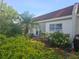 The backyard area has a small patio with furniture, landscaping, and views of the home at 13813 Mission Oaks Blvd, Seminole, FL 33776