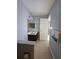 Bathroom vanity with granite countertop and open doorway at 13813 Mission Oaks Blvd, Seminole, FL 33776