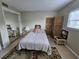 This bedroom features a bed, a woven style screen, and a mirrored closet at 13813 Mission Oaks Blvd, Seminole, FL 33776