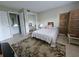 Cozy bedroom features a queen bed, neutral colors, and a decorative screen at 13813 Mission Oaks Blvd, Seminole, FL 33776