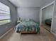 Bright bedroom with large window and mirrored closet at 13813 Mission Oaks Blvd, Seminole, FL 33776