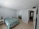Comfortable bedroom featuring a mirrored closet and ensuite bathroom at 13813 Mission Oaks Blvd, Seminole, FL 33776