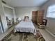 This bedroom features a bed, a woven style screen, and a mirrored closet at 13813 Mission Oaks Blvd, Seminole, FL 33776