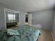 Bedroom featuring a mirrored closet and ensuite bathroom entrance at 13813 Mission Oaks Blvd, Seminole, FL 33776