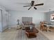 Inviting living room featuring a comfortable sofa, ceiling fan, and neutral decor at 13813 Mission Oaks Blvd, Seminole, FL 33776