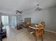 Cozy living and dining area with tile floors, ceiling fan, and dining table at 13813 Mission Oaks Blvd, Seminole, FL 33776