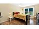 Bedroom with natural light, warm colors, and wood floors at 13902 Bardmoor Pl # B, Tampa, FL 33618