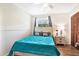 Comfortable bedroom featuring hardwood floors, white trim, and closet at 13902 Bardmoor Pl # B, Tampa, FL 33618