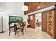 Bright dining room with wood paneled walls and natural light from the window at 13902 Bardmoor Pl # B, Tampa, FL 33618