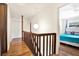 Upstairs hallway with wood floors leading to bedrooms at 13902 Bardmoor Pl # B, Tampa, FL 33618
