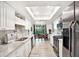 Bright kitchen featuring stainless steel appliances, and a view from the kitchen window at 13902 Bardmoor Pl # B, Tampa, FL 33618