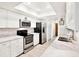 Well-lit kitchen featuring stainless steel appliances, and white cabinets at 13902 Bardmoor Pl # B, Tampa, FL 33618