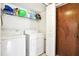 Bright laundry room with washer, dryer and storage shelf at 13902 Bardmoor Pl # B, Tampa, FL 33618