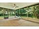 Enclosed porch with ceiling fan and views of the backyard at 13902 Bardmoor Pl # B, Tampa, FL 33618
