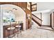 Wet bar featuring brick arch and wood cabinets, conveniently located off the living room at 13902 Bardmoor Pl # B, Tampa, FL 33618
