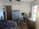 Bedroom with neutral walls, ceiling fan, large window, and furniture at 1425 Corner Oaks Dr, Brandon, FL 33510