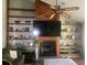 Cozy living room featuring a fireplace, built-in shelves, ceiling fan, and a television above the fireplace at 1425 Corner Oaks Dr, Brandon, FL 33510