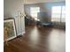 Living room with hardwood floors, large windows, and neutral-colored walls, and a flat screen TV at 1425 Corner Oaks Dr, Brandon, FL 33510