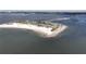Aerial shot of a sandy beach, the blue ocean, and a strip of land connecting the beach to another land mass at 1500 Sunset Rd # C7, Tarpon Springs, FL 34689