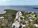 Gorgeous aerial view of waterfront condos featuring a pool, tennis court, and breathtaking bay views at 1500 Sunset Rd # C7, Tarpon Springs, FL 34689