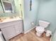 Bathroom with fresh vanity, sleek fixtures, and blue accent wall with nautical decor at 1500 Sunset Rd # C7, Tarpon Springs, FL 34689