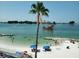 Picturesque beach view with clear water, palm trees, and a pirate ship sailing nearby at 1500 Sunset Rd # C7, Tarpon Springs, FL 34689