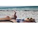Relaxing beach scene with sand, ocean in the background, and personal belongings creating a tranquil, vacation atmosphere at 1500 Sunset Rd # C7, Tarpon Springs, FL 34689