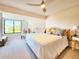 Comfortable bedroom with a ceiling fan and a window with shutter blinds at 1500 Sunset Rd # C7, Tarpon Springs, FL 34689