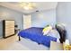 Comfortable bedroom with natural light, a dresser, and blue walls at 1500 Sunset Rd # C7, Tarpon Springs, FL 34689