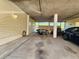 Under-building carport with table and chairs offers shade and parking for residents and guests at 1500 Sunset Rd # C7, Tarpon Springs, FL 34689