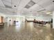 Spacious community room with tile floors, multiple seating areas, and a large window at 1500 Sunset Rd # C7, Tarpon Springs, FL 34689