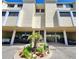 Condo exterior featuring covered parking, landscaped flower bed, and direct access at 1500 Sunset Rd # C7, Tarpon Springs, FL 34689