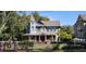 Charming blue Victorian home with ornate porch details and manicured landscaping at 1500 Sunset Rd # C7, Tarpon Springs, FL 34689