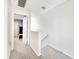 Hallway with carpeted floors leading to the bedrooms at 1500 Sunset Rd # C7, Tarpon Springs, FL 34689