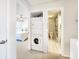 Hallway with a stacked washer and dryer, leading to a bedroom and a bathroom with a shower at 1500 Sunset Rd # C7, Tarpon Springs, FL 34689