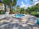 Outdoor hot tub and lounge area with manicured landscaping and ample seating for relaxation at 1500 Sunset Rd # C7, Tarpon Springs, FL 34689