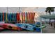 Colorful array of kayaks lined up by the beach, set against a backdrop of a beautiful sunset at 1500 Sunset Rd # C7, Tarpon Springs, FL 34689