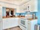 Bright kitchen features white cabinets, wood countertops, and blue walls at 1500 Sunset Rd # C7, Tarpon Springs, FL 34689