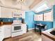 Well-lit kitchen features white appliances, light wood countertops, and a breakfast nook by a window at 1500 Sunset Rd # C7, Tarpon Springs, FL 34689