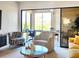 Cozy living space featuring a glass table, decorative chairs, and sliding glass doors to the outside at 1500 Sunset Rd # C7, Tarpon Springs, FL 34689