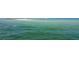 Expansive view of the ocean featuring clear turquoise water and a sandy shoal with recreational boats in the distance at 1500 Sunset Rd # C7, Tarpon Springs, FL 34689