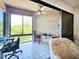 Enclosed patio with office setup, complemented by scenic views, and a cozy seating area at 1500 Sunset Rd # C7, Tarpon Springs, FL 34689