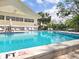Community pool with seating, clear blue water and a sunny area at 1500 Sunset Rd # C7, Tarpon Springs, FL 34689