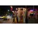 Restaurant exterior with outdoor lighting, signage, and pedestrian traffic at night at 1500 Sunset Rd # C7, Tarpon Springs, FL 34689